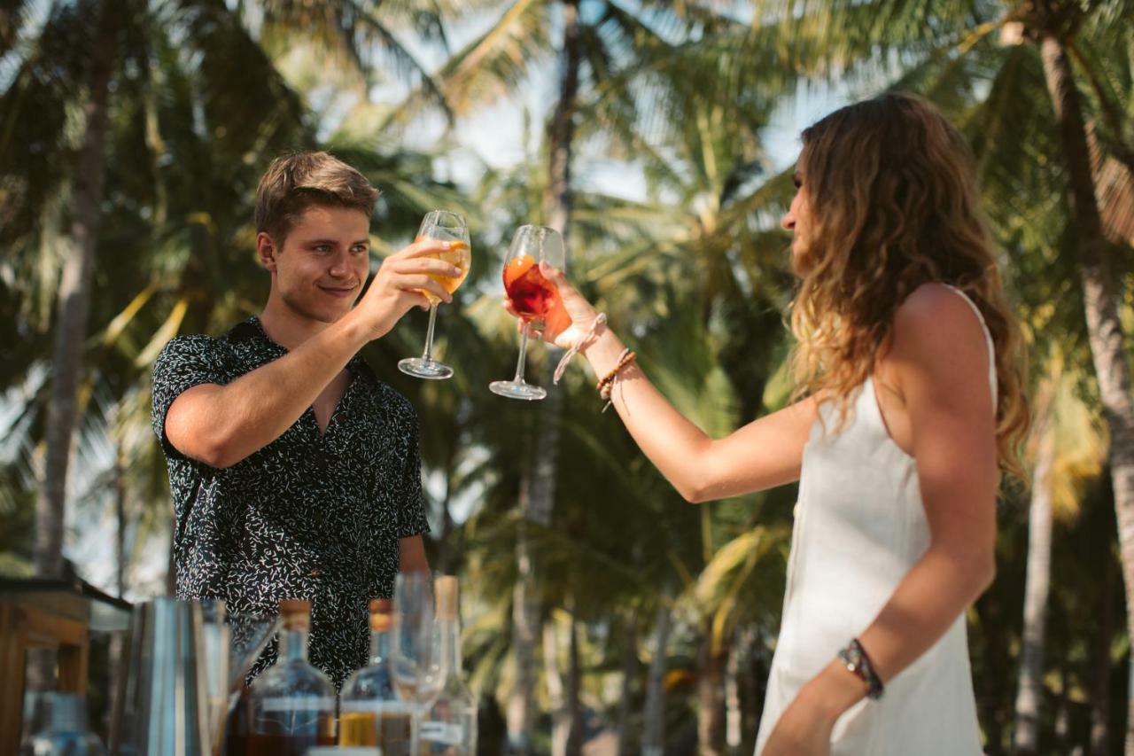 Oceanica Resort Panglao, Bohol Exterior foto Two people toasting with wine